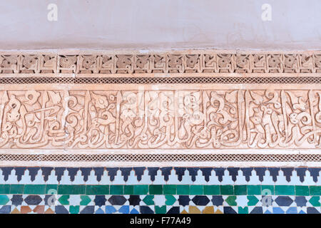 Ornate islamic calligraphy in the courtyard of the Ali Ben Youssef Medersa, Marrakech, Morocco Stock Photo