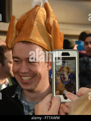 New York, USA. 25th November, 2015. Macy's Thanksgiving day parade. A parade goer has his photo taken with a turkey hat, while waiting for the start of Macy’s Thanksgiving Day Parade, Thursday, Nov. 26, 2015, in New York. Credit:  Shoun Hill/Alamy Live News Stock Photo