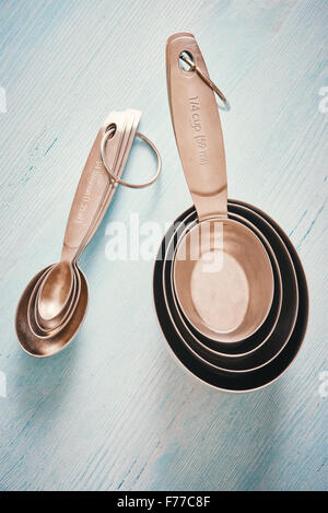 Measuring spoons cups on blue wooden table Stock Photo