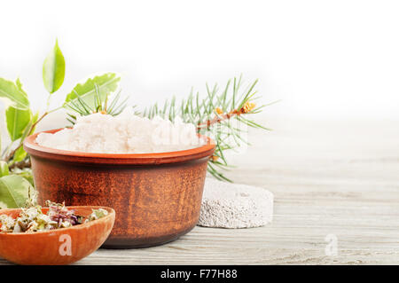 Aromatic bath salt and dried herbs on a wooden surface Stock Photo