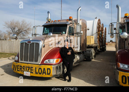 Female, Dutch truck driver poses beside her 'Watt and Stewart' Canadian company peterbilt trucks in Dalhart, Texas, USA Stock Photo