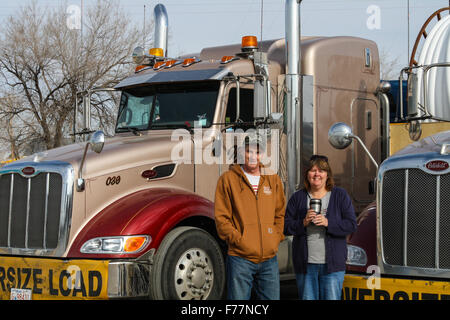 Foreign truck drivers pose beside their 'Watt and Stewart' Canadian company peterbilt trucks in Dalhart, Texas, USA Stock Photo