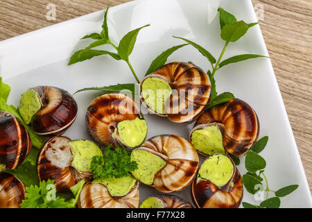 Escargot with parsley butter with salat leaves and mint Stock Photo