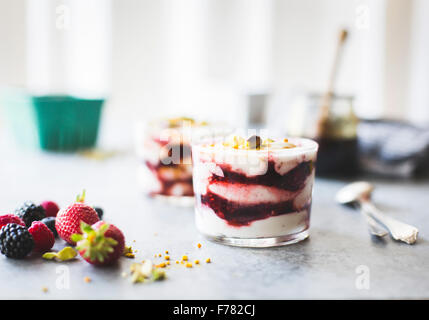 Summer berries yoghurt fools dessert with buckwheat honey. Stock Photo