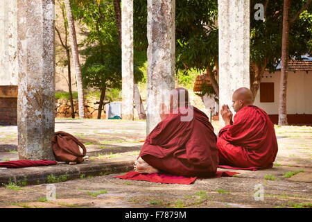 Sri Lanka - monks praying at Mihintale Temple, Ambasthale Dagoba, UNESCO Stock Photo