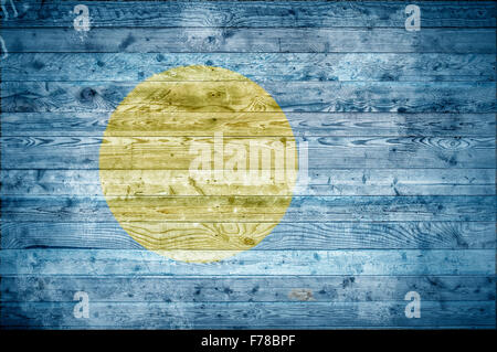 A vignetted background image of the flag of Palau onto wooden boards of a wall or floor. Stock Photo