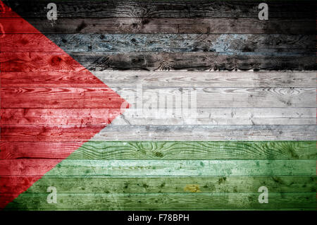 A vignetted background image of the flag of Palestine onto wooden boards of a wall or floor. Stock Photo