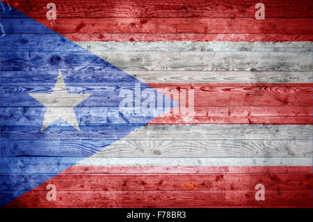 A vignetted background image of the flag of Puerto Rico onto wooden boards of a wall or floor. Stock Photo