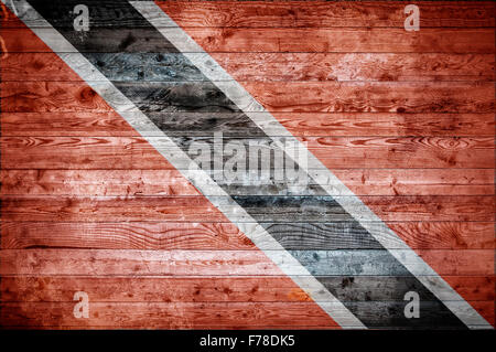 A vignetted background image of the flag of Trinidad and Tobago onto wooden boards of a wall or floor. Stock Photo