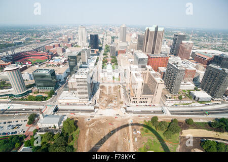 St Louis Gateway Arch shadow over construction site below with the city commercial center, buildings and ball park stadium Stock Photo
