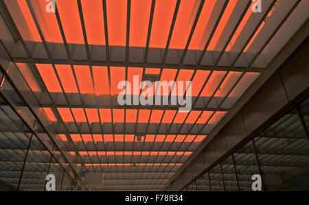 A modern open roof with red light and strip pattern in building Stock Photo