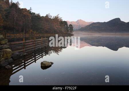 An autumnal view of the Langdale Pikes, taken at dawn from Blea Tarn in the Lake District National Park. Stock Photo