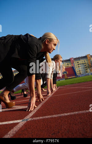 business people running together on racing track Stock Photo