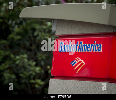 Seattle, Washingtion, USA. 23rd Nov, 2015. A Bank of America ATM with small roof, lights and security camera, located at Seattle Center, provides clients easy access to banking information and cash using a debit and or credit card. The BOFA atm is easily identified with letters printing out ''Bank of America, '' along with a small stylized design meant to represent the American flag in red, white and blue. © David Bro/ZUMA Wire/Alamy Live News Stock Photo