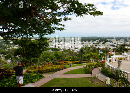 Person looking at the view of the city of Ponce from the Serralles Castle's garden. Ponce, Puerto Rico. USA territory. Caribbean Stock Photo