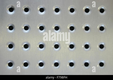 shiny brushed Metal surface with holes Stock Photo