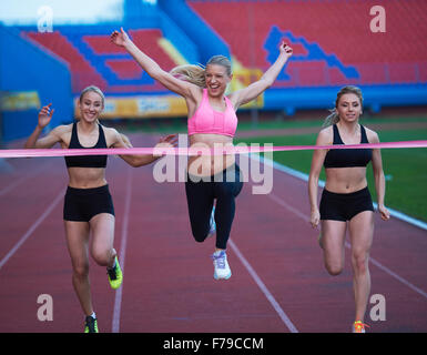 Female Runners Finishing athletic  Race Together Stock Photo