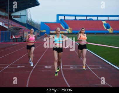 Female Runners Finishing athletic  Race Together Stock Photo