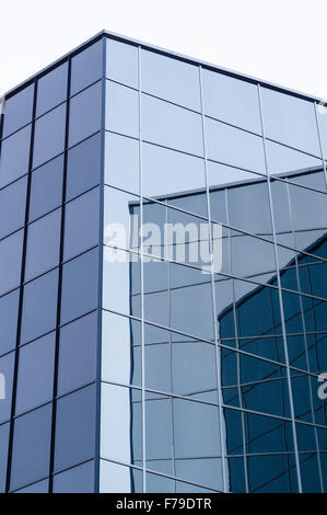 Abstract view of modern glass and steel building with wall reflections Stock Photo