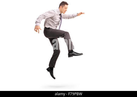 Full length profile shot of a young businessman jumping in the air shot in mid-air isolated on white background Stock Photo