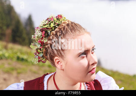 Portrait of a young girl in traditional costume with headdress Stock Photo