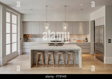 Kitchen with marble island in modern family home 2012, design by De Rosee Sa Stock Photo