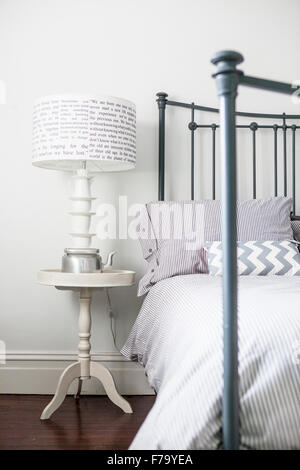 Metal bed and teacup lampstand in Sydney home of designer and Heritage Consultant Janine Hendry. Stock Photo