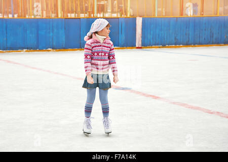 girl ice skating on rink Stock Photo