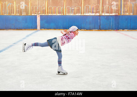 girl ice skating on rink Stock Photo