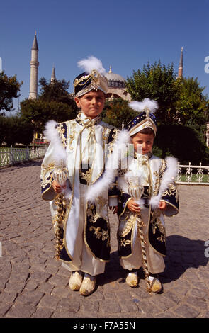 Two brothers who will soon be circumcised pose in front of the famous Hagia Sofia in Istanbul, Turkey. Stock Photo
