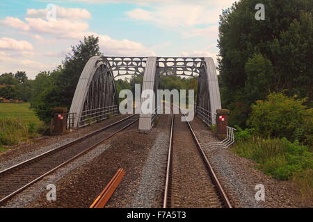 A steel box girder bridge spanning the Thames with two lines going through it and a steel superstructure Stock Photo