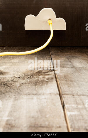 The image shows clouds of clay imitating the clouds and the concept of technological clouding over wooden background as if it we Stock Photo