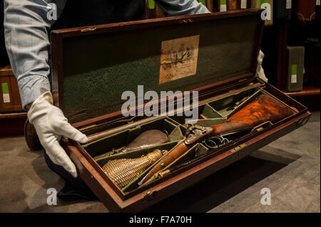 London, UK.  27 November 2015.  Preview of the 'Guns made for Royalty and Nobility' sale, by Gavin Gardiner Ltd, of modern and vintage sporting guns and rifles at Sotheby's in London, ahead of their sale on 1 December. Pictured: A technician shows a 20-bore percussion gun by Joseph Manton, converted by Tanner, built for The Prince Adolphus, 1st Duke of Cambridge, £4,000-6,000.    Credit:  Stephen Chung / Alamy Live News Stock Photo