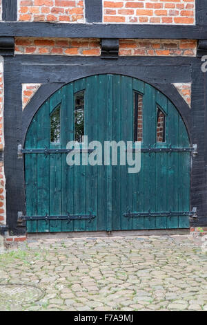 Old, green double door in a half-timbered house. Shot from Stade, Germany Stock Photo