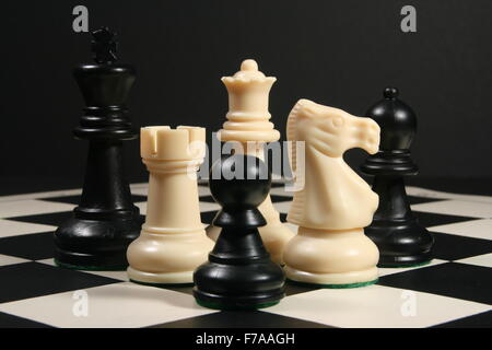 Chess pieces on board with black background Stock Photo