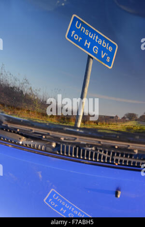 unsuitable for hgv's warning sign on country road reflected in vehicle windscreen york united kingdom Stock Photo