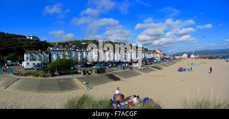 View of  Aberdyfi, Gwynedd, Wales UK. Showing beach with family groups on and colourful buildings. The sky is blue. Stock Photo