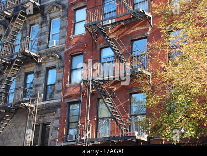 Perspective of Fire Escape Steel Ladders on Apartment Building Block in New York Stock Photo