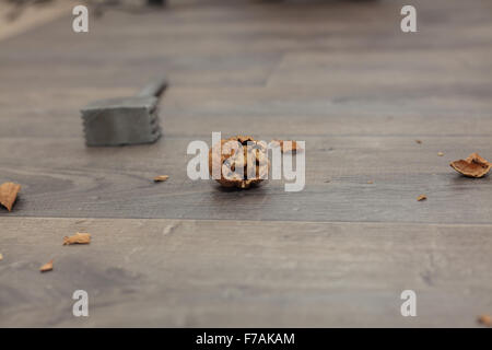 Walnuts with a nutcracker on a wooden board (Shallow DOF). Stock Photo
