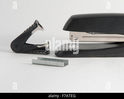 Stapler, staples and staple remover against a white background Stock Photo