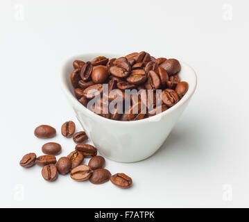A bowl of roasted coffee beans isolated on white Stock Photo