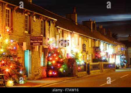 Illuminated Christmas trees line the main street in Castleton; a village in the Peak District, Derbyshire UK Stock Photo