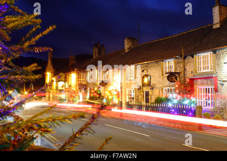 Decorated Christmas trees line the main street in Castleton; a traditional British village in the Peak District, Derbyshire UK Stock Photo