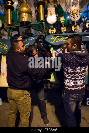 An Iranian Man Carries An Alam Is Helped By Shiite Muslim Mourners To Keep His Balance On Ashura, The Day Of The Death Of Hussein, Golestan Province, Gorgan, Iran Stock Photo