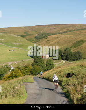 Cycling in the Yorkshire Dales National Park, UK. Cyclists climbing Darnbrook Fell on a beautiful September morning. Stock Photo