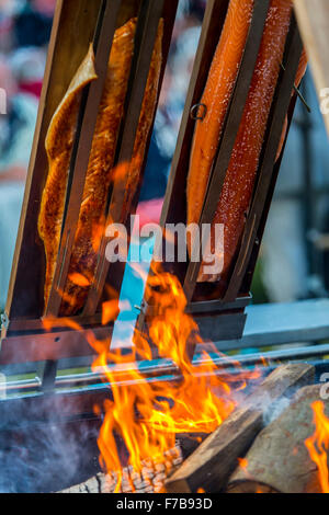 Salmon is smoked and grilled over open fire, specialty on a food market Stock Photo