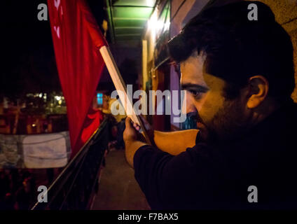 Iranian Shiite Muslims Man Holding A Red Flag During Ashura, The Day Of The Death Of Imam Hussein, Golestan Province, Gorgan, Iran Stock Photo