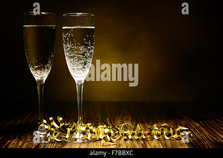 two glasses of champagne on a wooden background Stock Photo