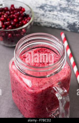 berry smoothie of cowberry, cranberries in a glass on a wooden background Stock Photo