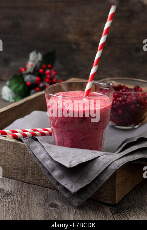 berry smoothie of cowberry, cranberries in a glass on a wooden background Stock Photo